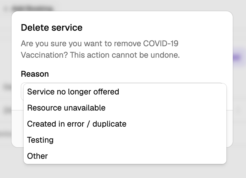 The Delete service dialog asking to confirm removing COVID-19 Vaccination, with the Reason list open showing Service no longer offered, Resource unavailable, Created in error / duplicate, Testing and Other